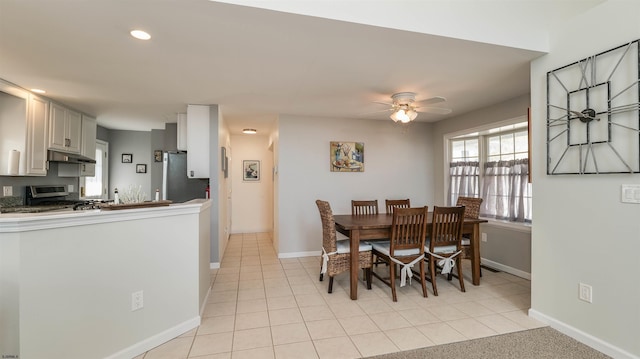 dining space with recessed lighting, light tile patterned flooring, a ceiling fan, and baseboards