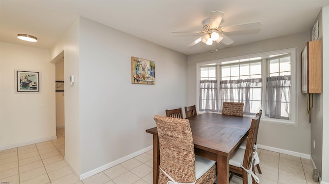 dining room with light tile patterned flooring, baseboards, and a ceiling fan