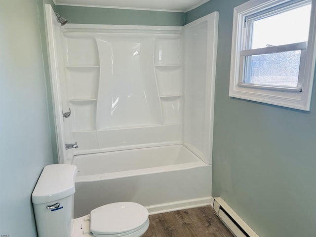 full bathroom with a baseboard heating unit, toilet, wood finished floors, and shower / tub combination