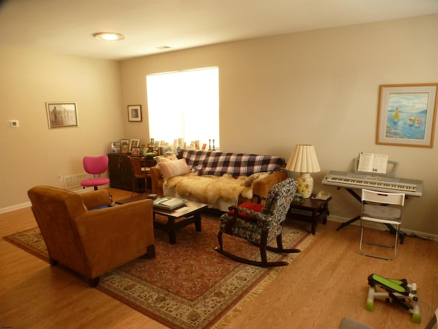 living area featuring wood finished floors and baseboards