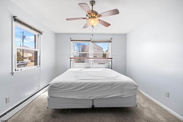 carpeted bedroom with a ceiling fan, baseboards, and a baseboard radiator