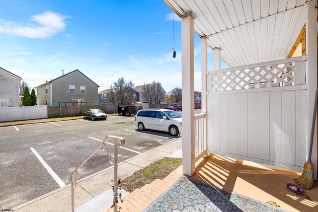 uncovered parking lot featuring fence