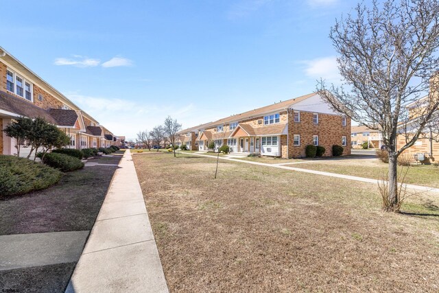 view of home's community with a residential view and a lawn