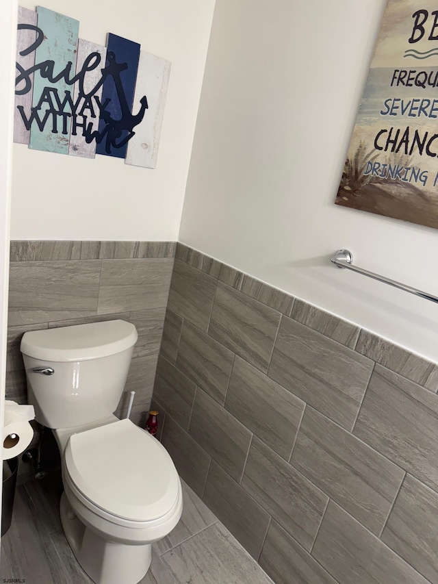 110 N Vermont Ave, Atlantic City, NJ 08401 - bathroom with tile walls, toilet, and a wainscoted wall