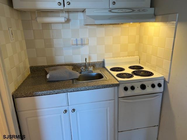 108 S Montpelier Ave Unit 201, Atlantic City, NJ 08401 - kitchen featuring white electric range, tasteful backsplash, white cabinetry, a sink, and exhaust hood