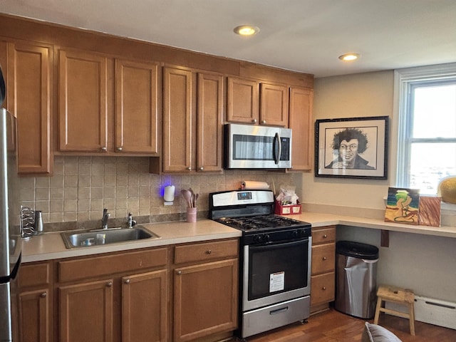 kitchen featuring backsplash, light countertops, a sink, and appliances with stainless steel finishes
