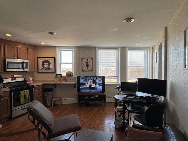 living area featuring baseboard heating and dark wood-style flooring