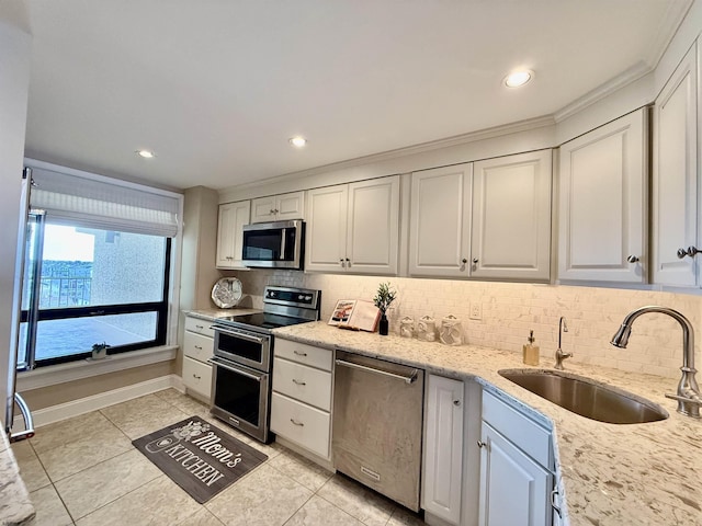 336 Bay Ave Unit 605, Ocean City, NJ 08226 - kitchen with light tile patterned flooring, a sink, tasteful backsplash, light stone countertops, and appliances with stainless steel finishes