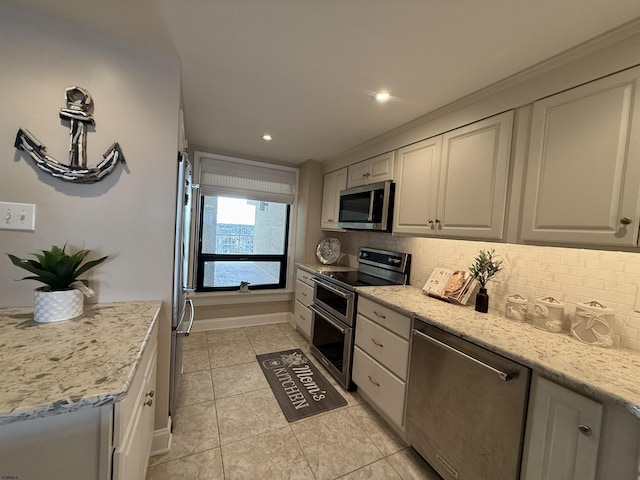 336 Bay Ave Unit 605, Ocean City, NJ 08226 - kitchen featuring light tile patterned flooring, tasteful backsplash, appliances with stainless steel finishes, and light stone counters