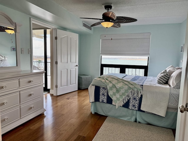 336 Bay Ave Unit 605, Ocean City, NJ 08226 - bedroom with a textured ceiling, visible vents, a ceiling fan, dark wood-type flooring, and access to exterior