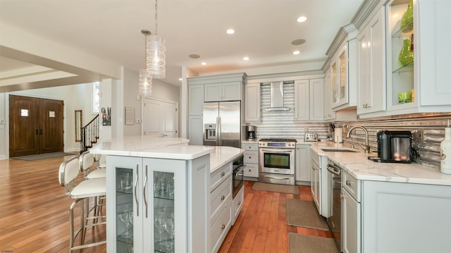 1905 Glenwood Dr, Ocean City, NJ 08226 - kitchen featuring a sink, stainless steel appliances, wall chimney exhaust hood, backsplash, and hardwood / wood-style floors