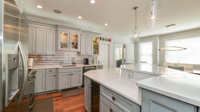 1905 Glenwood Dr, Ocean City, NJ 08226 - kitchen featuring a sink, appliances with stainless steel finishes, light wood-style floors, gray cabinets, and hanging light fixtures