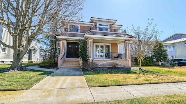 1905 Glenwood Dr, Ocean City, NJ 08226 - view of front of home featuring covered porch, stucco siding, a front yard, and a balcony