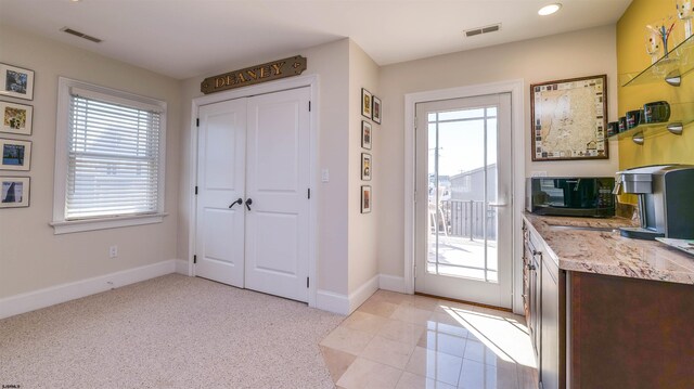 1905 Glenwood Dr, Ocean City, NJ 08226 - doorway with visible vents, a healthy amount of sunlight, and baseboards