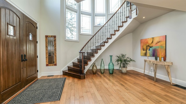 1905 Glenwood Dr, Ocean City, NJ 08226 - entryway featuring a high ceiling, stairway, visible vents, baseboards, and hardwood / wood-style floors