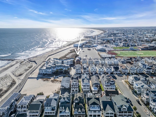 aerial view featuring a water view, a beach view, and a residential view
