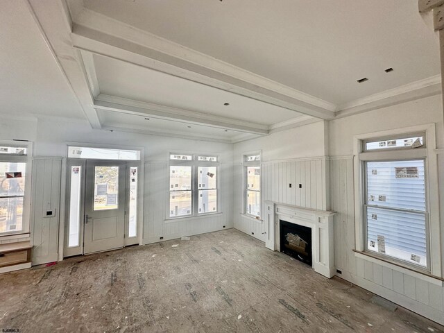 unfurnished living room featuring a fireplace, crown molding, and beam ceiling