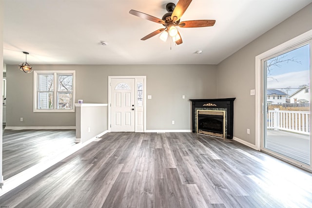 28 W Thompson Ave, Pleasantville, NJ 08232 - unfurnished living room with baseboards, a fireplace, wood finished floors, and ceiling fan