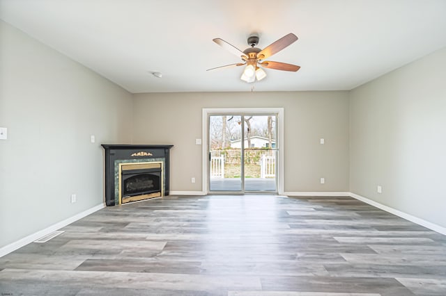 28 W Thompson Ave, Pleasantville, NJ 08232 - unfurnished living room featuring baseboards, visible vents, a ceiling fan, a fireplace, and wood finished floors