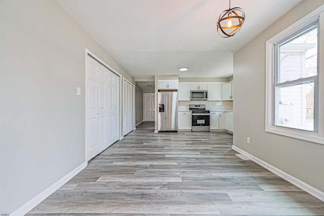 28 W Thompson Ave, Pleasantville, NJ 08232 - unfurnished living room featuring light wood finished floors and baseboards