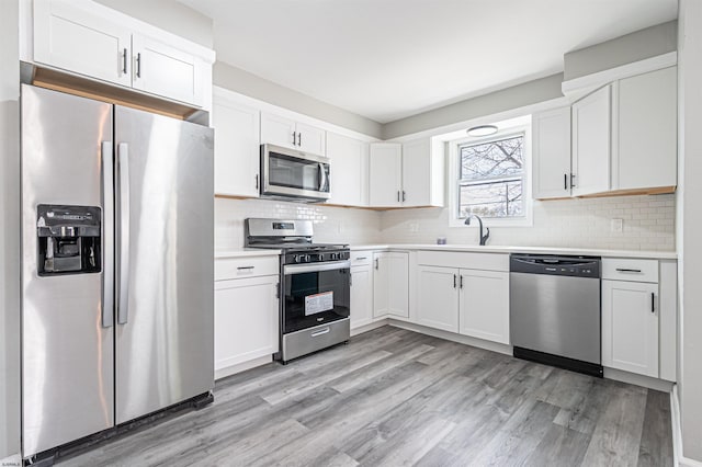 28 W Thompson Ave, Pleasantville, NJ 08232 - kitchen featuring light wood-style flooring, light countertops, a sink, and appliances with stainless steel finishes