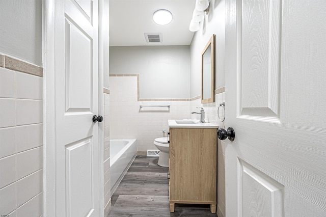 28 W Thompson Ave, Pleasantville, NJ 08232 - full bathroom with tile walls, visible vents, toilet, wood finished floors, and vanity