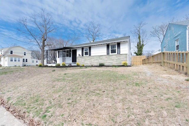 28 W Thompson Ave, Pleasantville, NJ 08232 - view of front of home featuring stone siding, a front yard, and fence