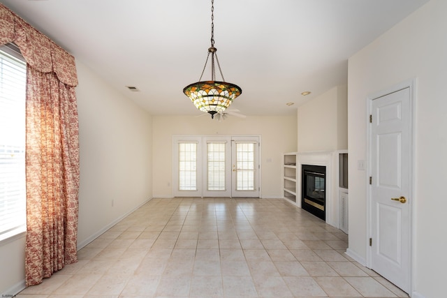 unfurnished living room featuring light tile patterned floors, baseboards, a glass covered fireplace, and visible vents