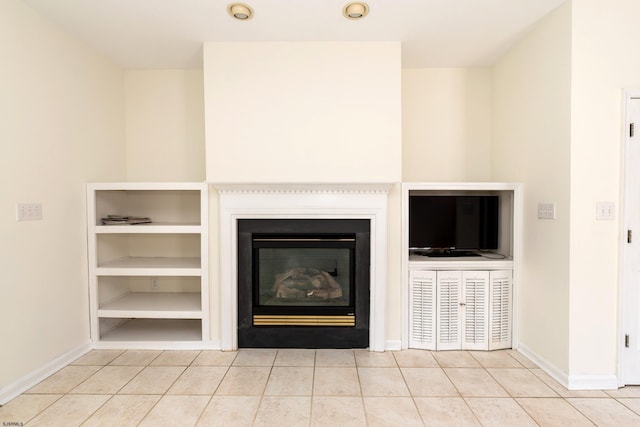 details featuring baseboards and a glass covered fireplace
