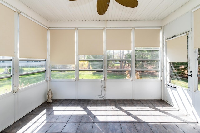 unfurnished sunroom with ceiling fan