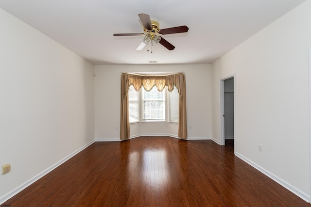 unfurnished room with visible vents, baseboards, a ceiling fan, and wood finished floors