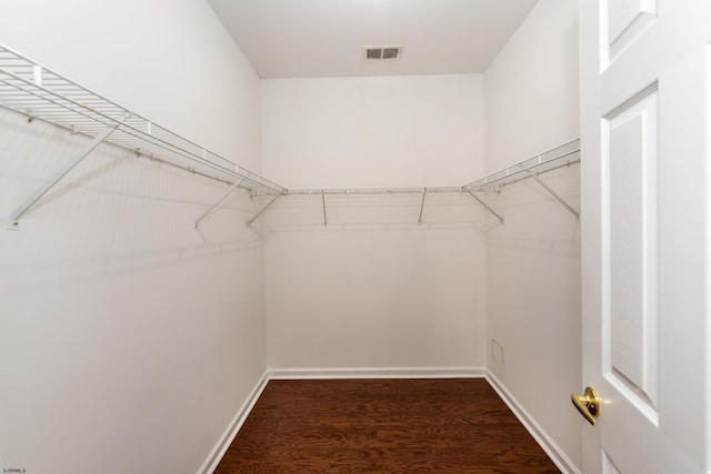walk in closet with visible vents and wood finished floors