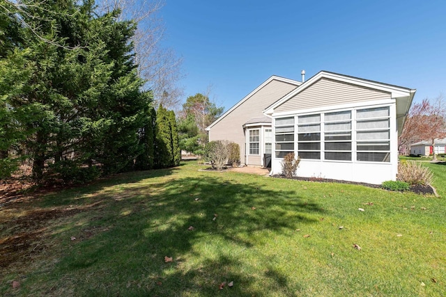 rear view of property featuring a lawn