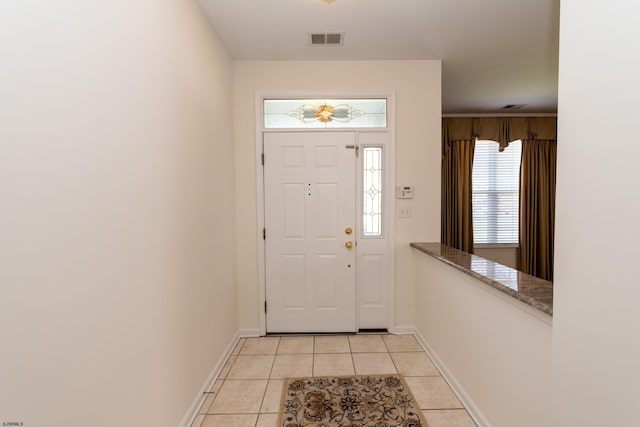 entrance foyer with visible vents, baseboards, and light tile patterned flooring