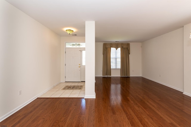 entryway featuring wood finished floors, baseboards, and visible vents
