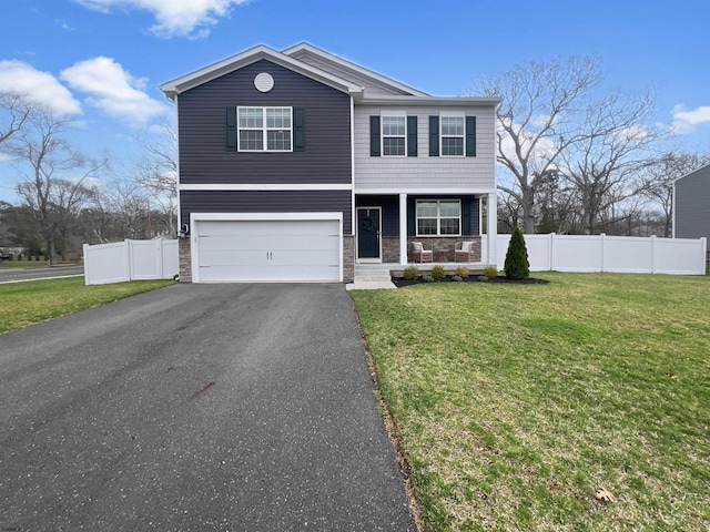 view of front facade featuring stone siding, a porch, driveway, and fence