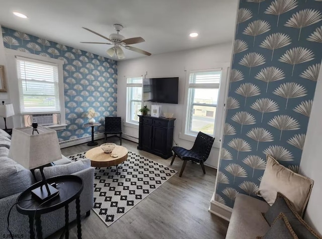 living area with ceiling fan, light wood finished floors, and wallpapered walls