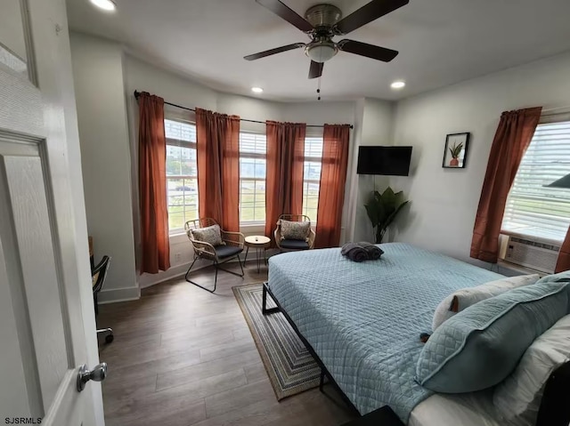 bedroom featuring baseboards, recessed lighting, cooling unit, a ceiling fan, and wood finished floors