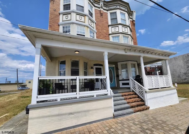 view of exterior entry featuring a porch