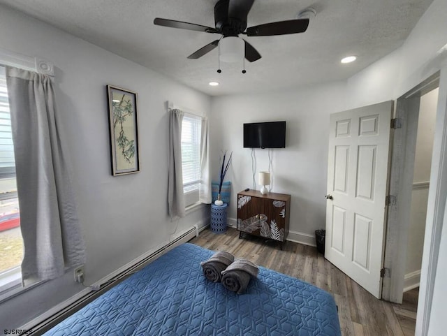 exercise area featuring wood finished floors, ceiling fan, baseboards, and recessed lighting