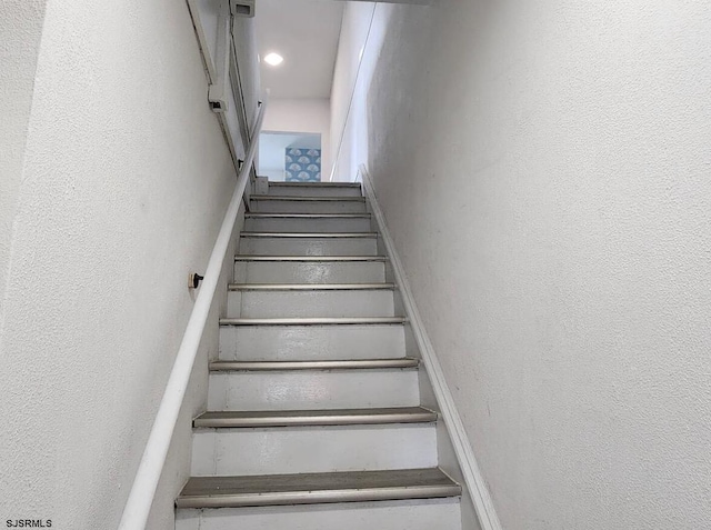 stairway with a textured wall