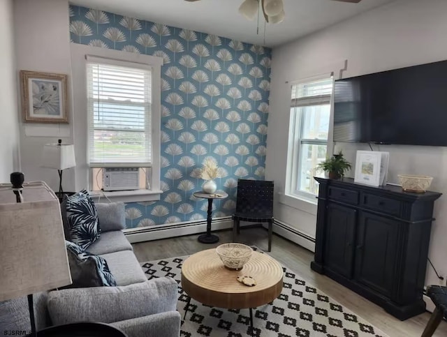 living room with ceiling fan, a healthy amount of sunlight, and wallpapered walls