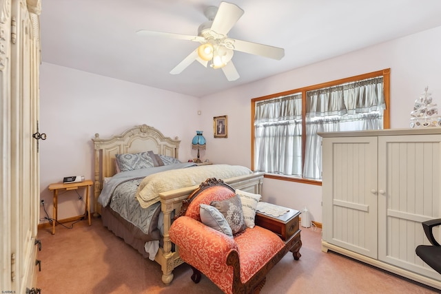 carpeted bedroom with baseboards and ceiling fan