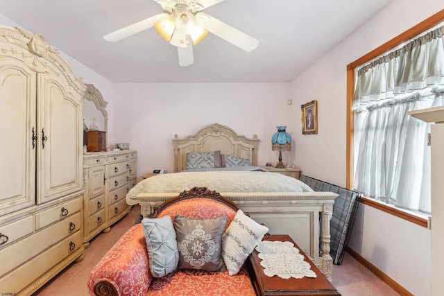 bedroom with baseboards, a ceiling fan, and light colored carpet