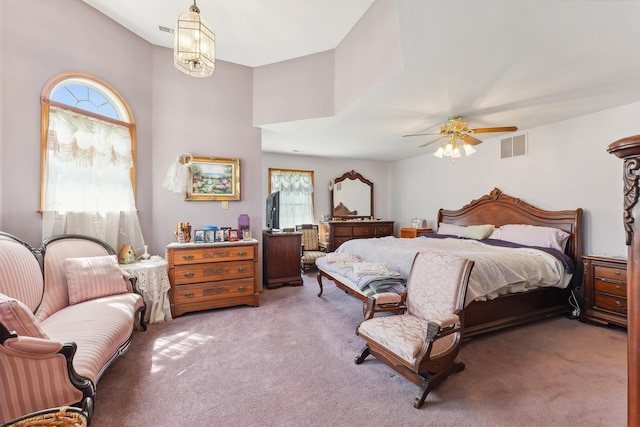 bedroom with ceiling fan, light carpet, and visible vents