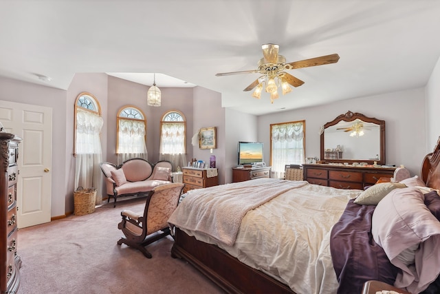 carpeted bedroom with ceiling fan and multiple windows
