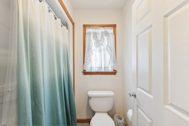 bathroom with toilet and baseboards