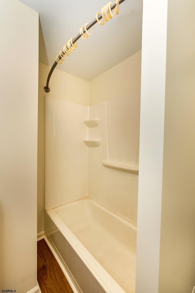 full bath featuring wood finished floors and walk in shower