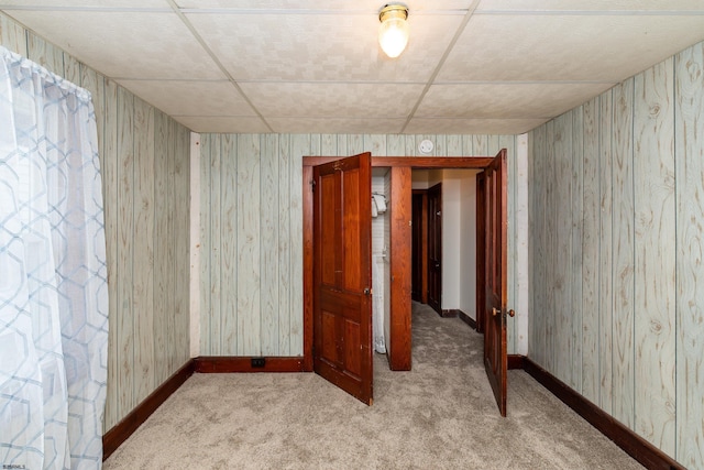 unfurnished room featuring baseboards, carpet flooring, and wallpapered walls