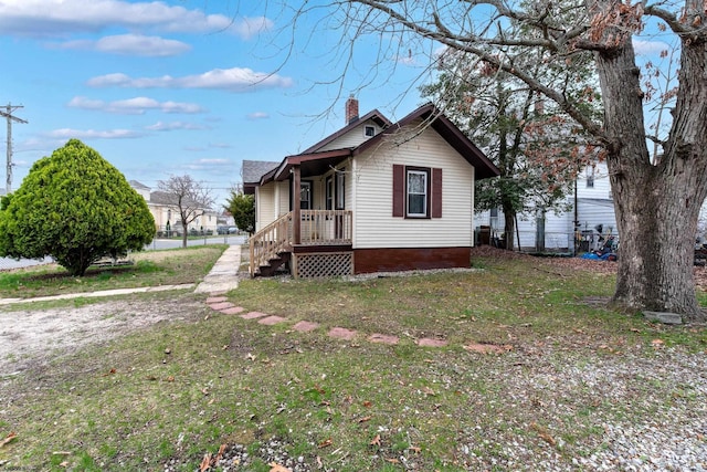 exterior space featuring a yard and a chimney